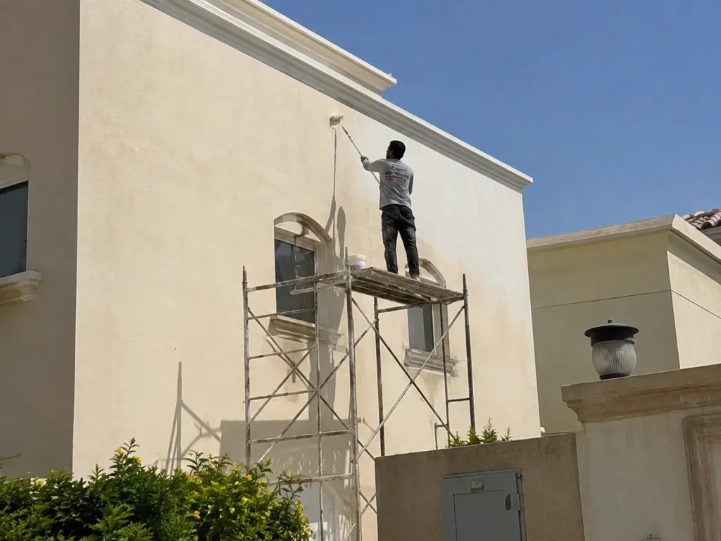 Painting services Dubai exterior villa wall on scaffolding