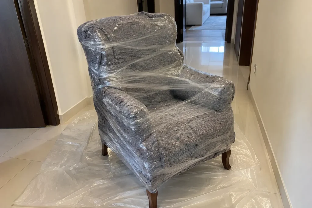 Furniture wrapped in blanket and stretch wrap for moving in rain Dubai